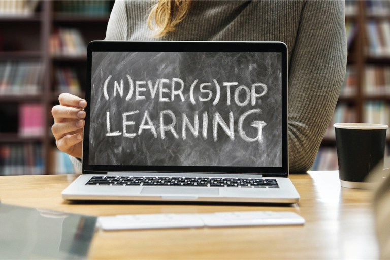 Photo of a laptop but the screen is actually a chalkboard that says "never stop learning"