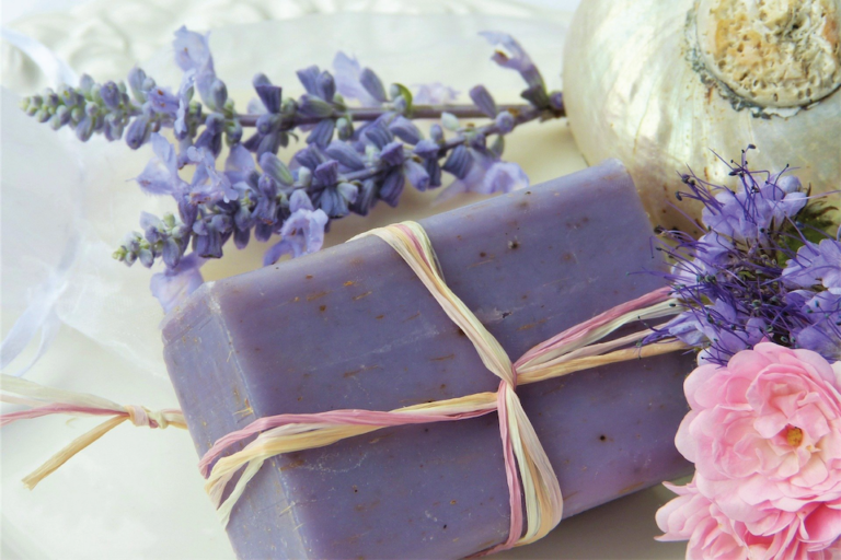 Photo of a bar of purple soap with lavender flowers